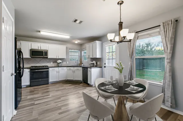 a kitchen with a table and chairs in it
