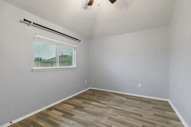 a view of room with window and hardwood floor