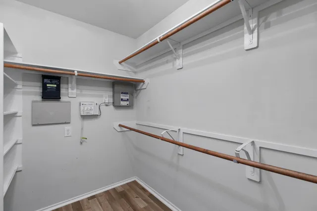 a view of storage and utility room with a ceiling fan