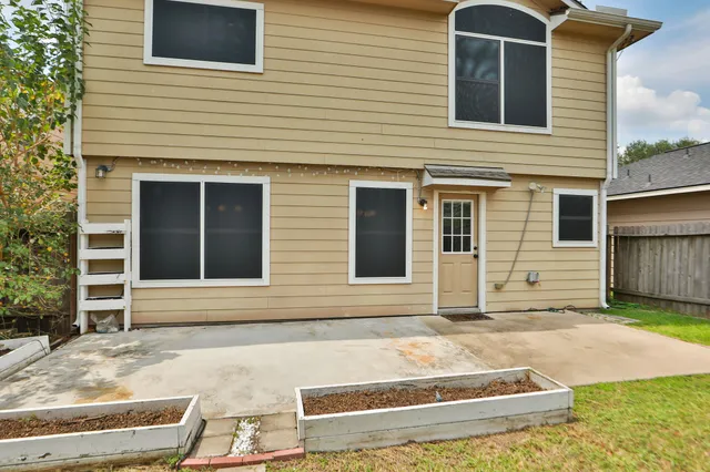 a view of a brick house with many windows