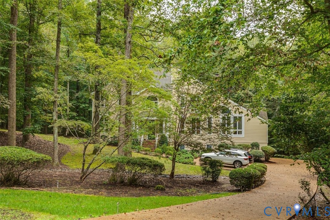 3820 Reeds Landing Circle Midlothian, VA 23113 - Photo 3 of 25 a view of a garden with plants and large trees