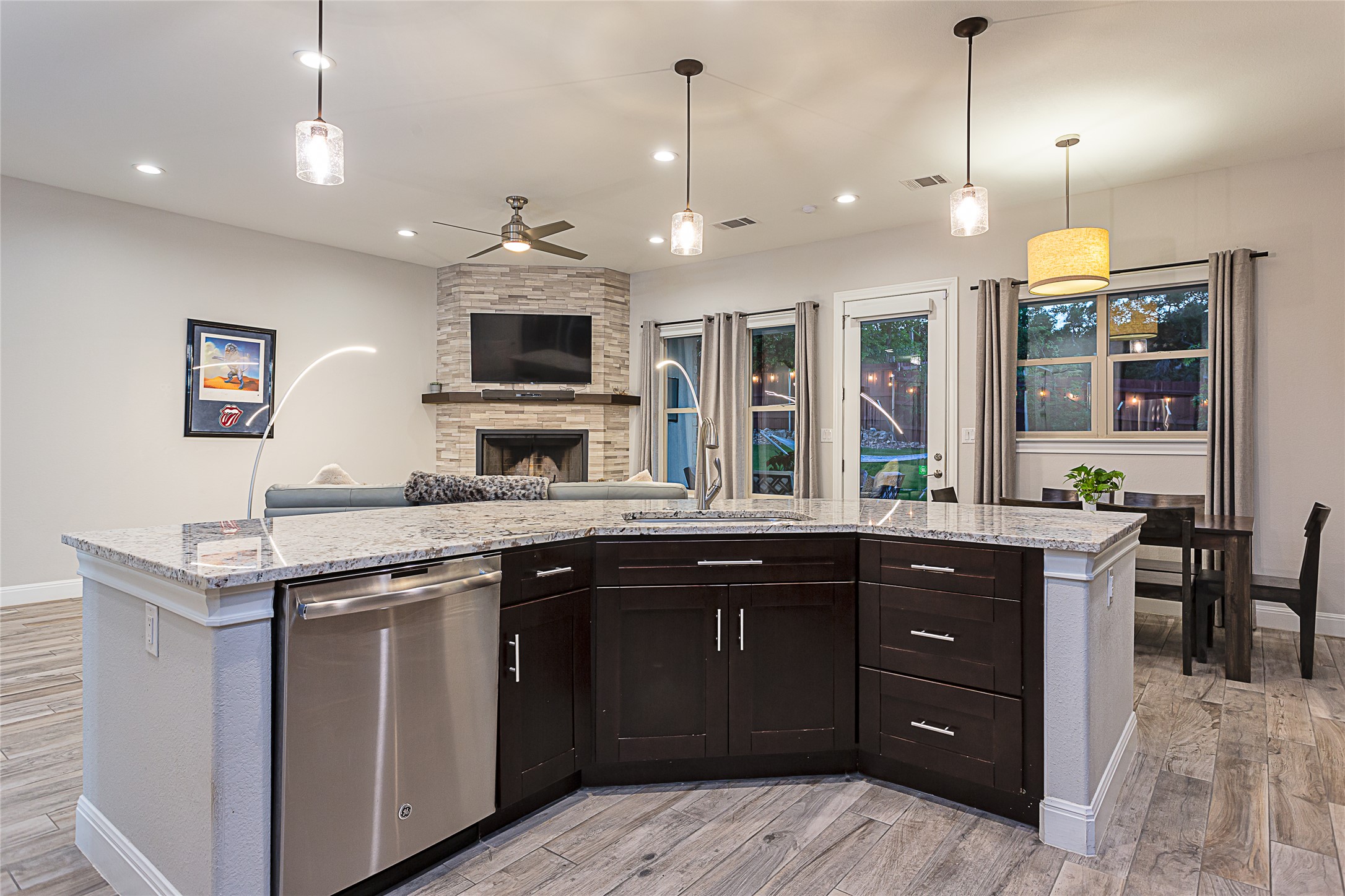 5608 Arroyo Road Austin, TX 78734 - Photo 12 of 39 Kitchen featuring stainless steel dishwasher, light wood-style floors, decorative light fixtures, a ceiling fan, and recessed lighting