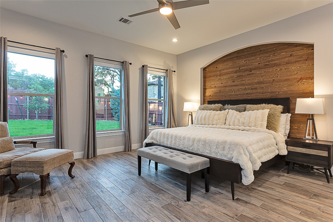 5608 Arroyo Road Austin, TX 78734 - Photo 20 of 39 Bedroom featuring light wood-type flooring, ceiling fan, wooden walls, and recessed lighting