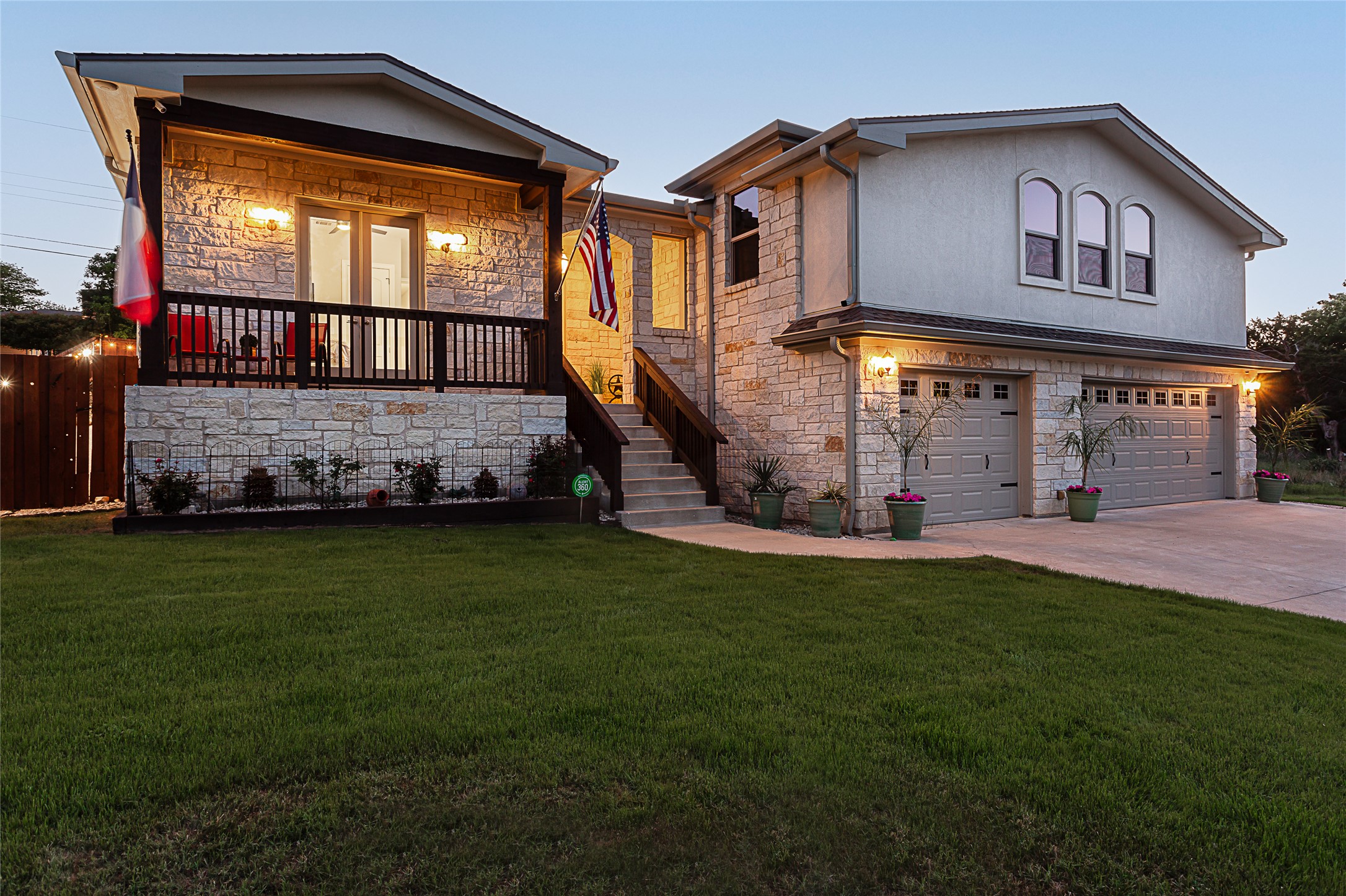 5608 Arroyo Road Austin, TX 78734 - Photo 2 of 39 View of front facade with stone siding, stairs, an attached garage, concrete driveway, and covered porch