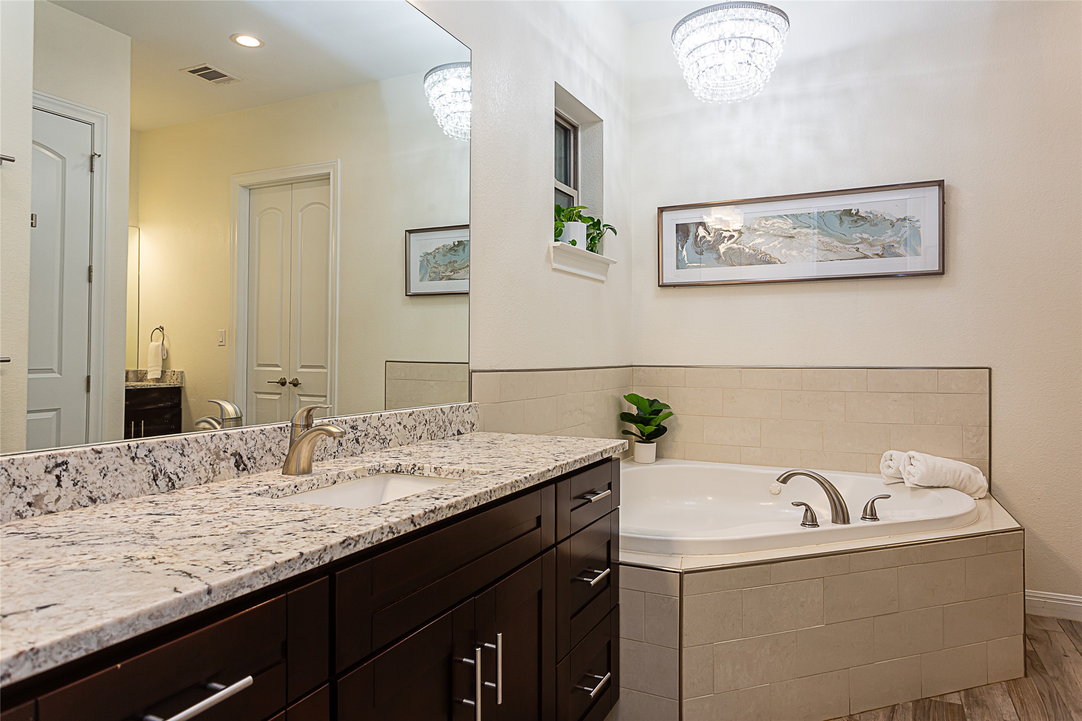 5608 Arroyo Road Austin, TX 78734 - Photo 23 of 39 Full bath with a garden tub, vanity, light wood-style flooring, and recessed lighting