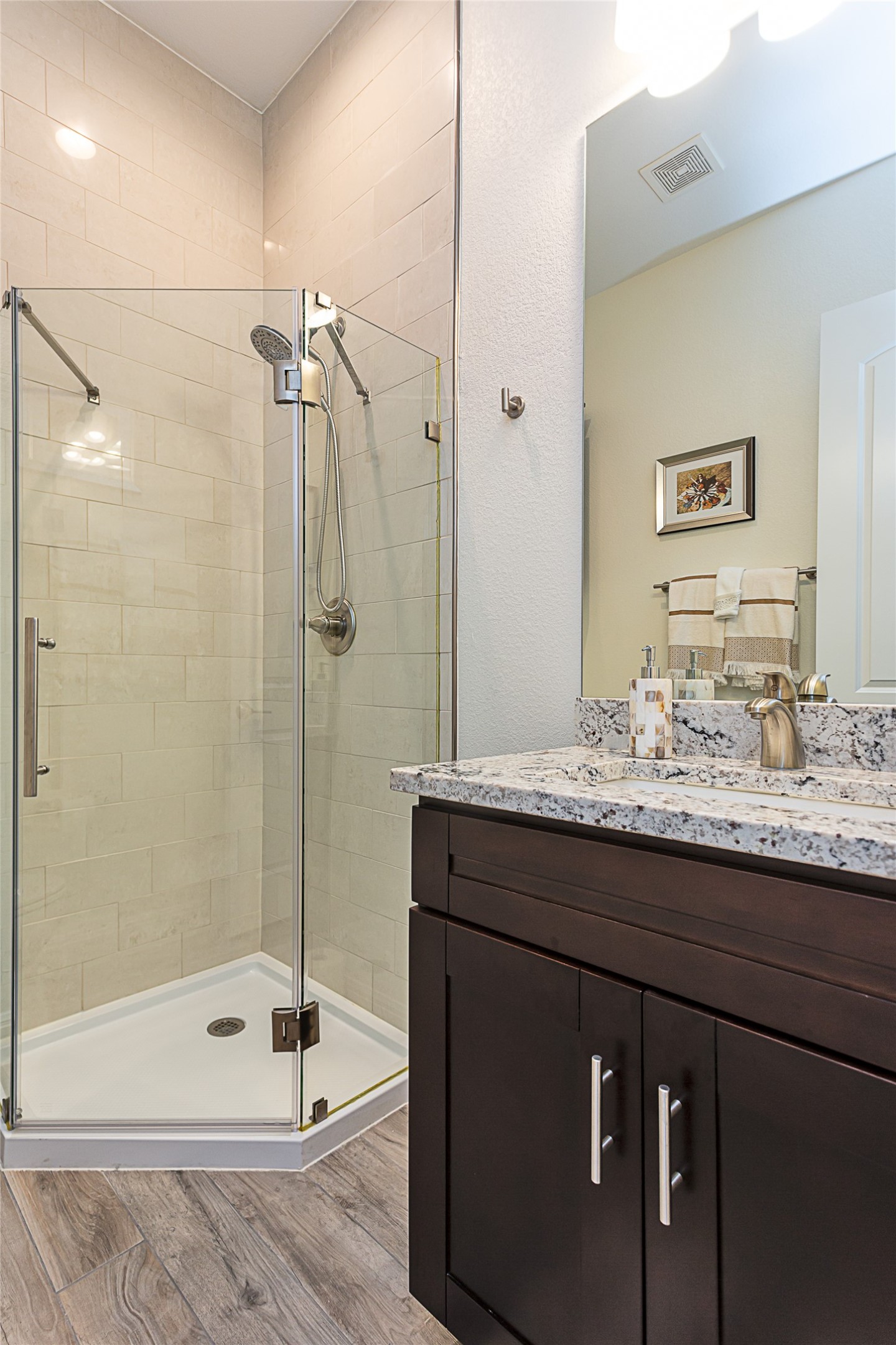 5608 Arroyo Road Austin, TX 78734 - Photo 29 of 39 Bathroom with light wood-type flooring, a stall shower, and vanity