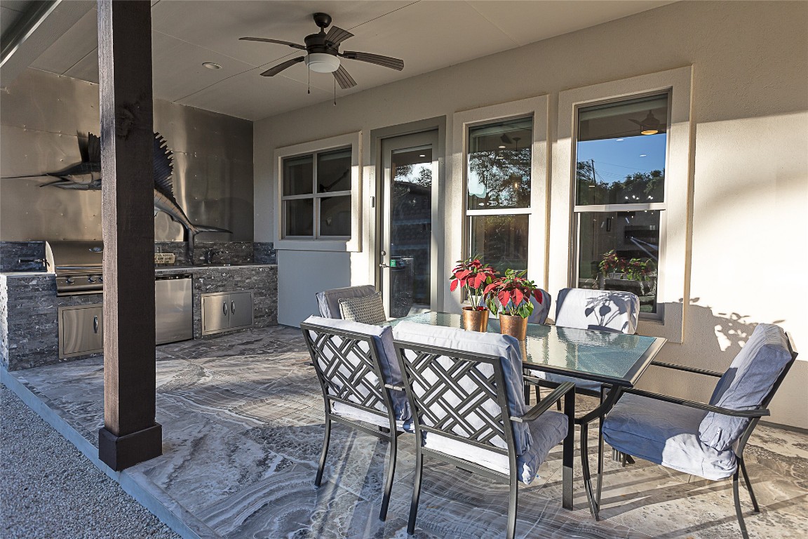 5608 Arroyo Road Austin, TX 78734 - Photo 35 of 39 View of patio featuring outdoor dining area, a ceiling fan, and exterior kitchen