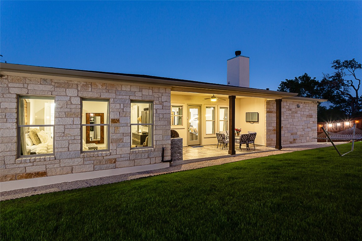 5608 Arroyo Road Austin, TX 78734 - Photo 6 of 39 Rear view of property with a ceiling fan, a patio area, a chimney, and a lawn