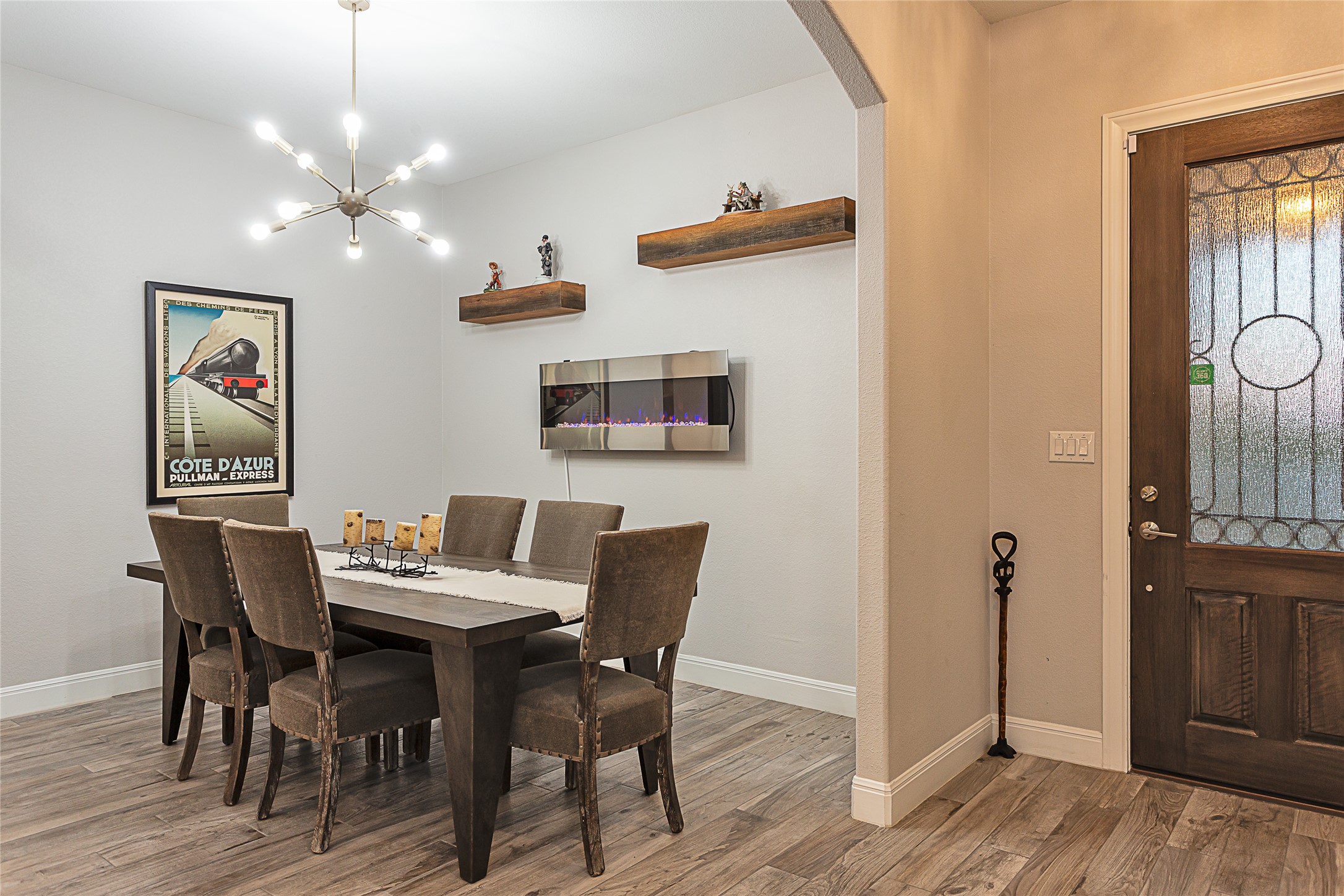 5608 Arroyo Road Austin, TX 78734 - Photo 9 of 39 Dining space featuring a chandelier, light wood-style flooring, and arched walkways
