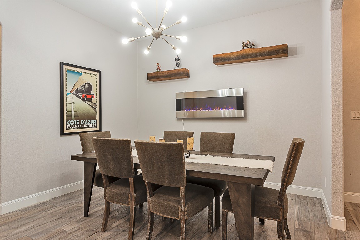 5608 Arroyo Road Austin, TX 78734 - Photo 9 of 39 Dining space with a chandelier and light wood-style floors