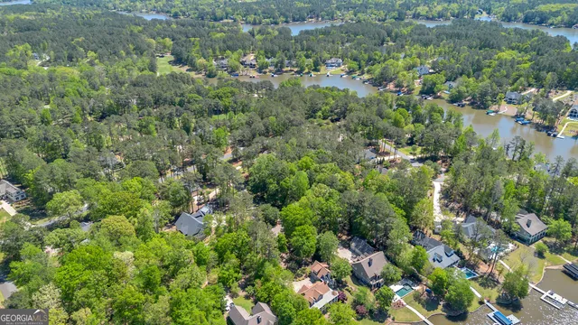 a view of a house with a lush green forest