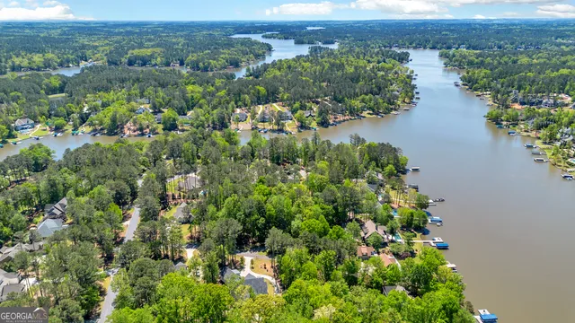 an aerial view of a house with a yard and lake view