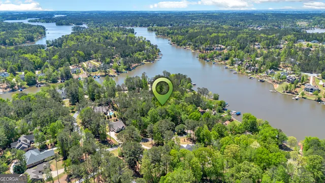 an aerial view of a house with a yard and lake view
