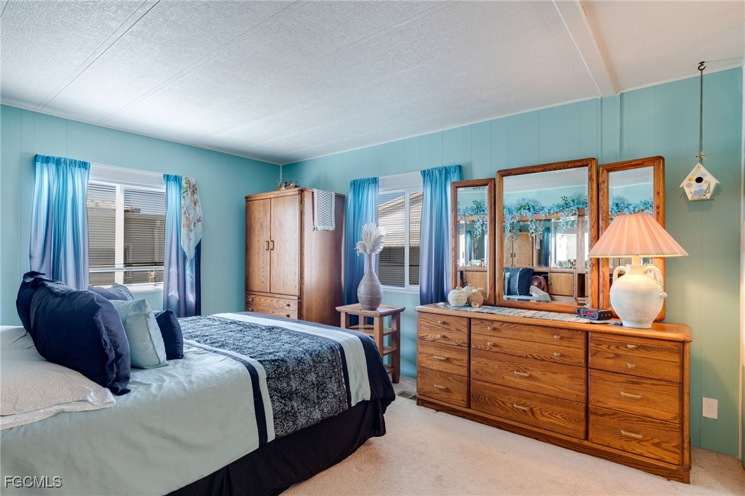 9324 Baron Road Bonita Springs, FL 34135 - Photo 14 of 22 a bedroom with a bed table closet and window