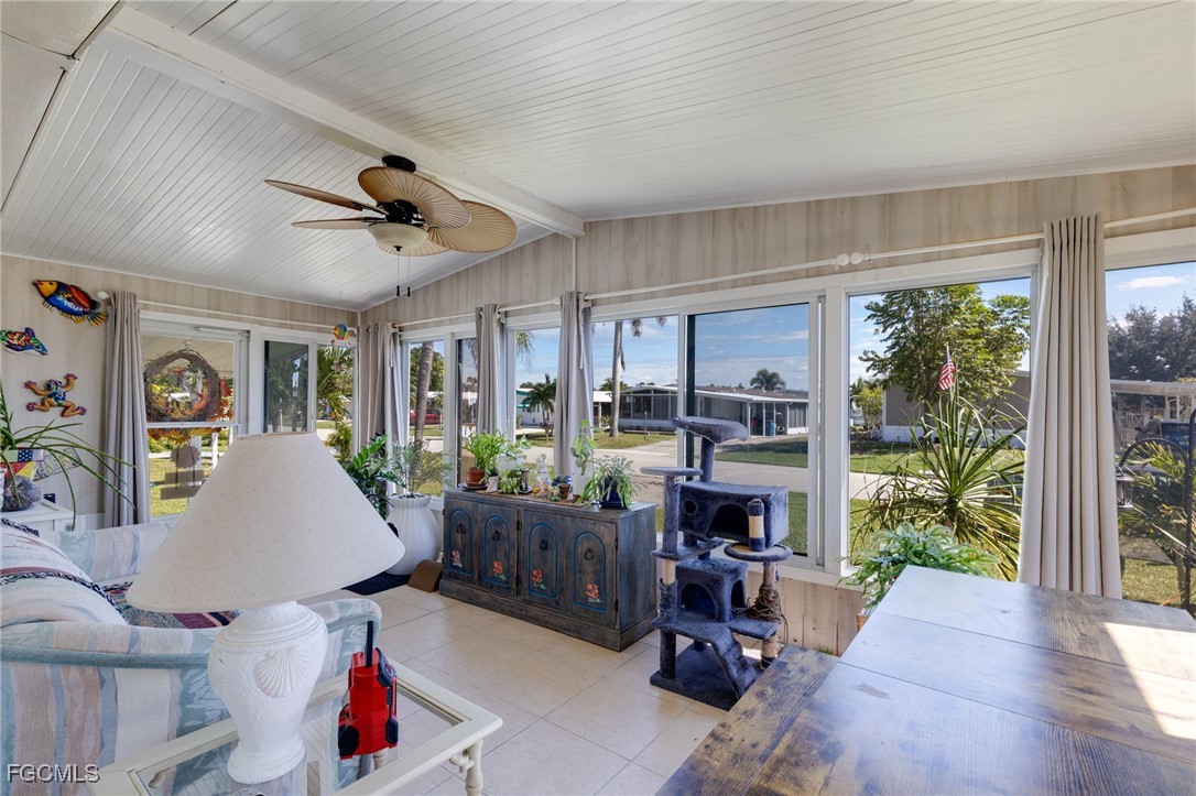 9324 Baron Road Bonita Springs, FL 34135 - Photo 18 of 22 a living room with furniture large window and a flat screen tv