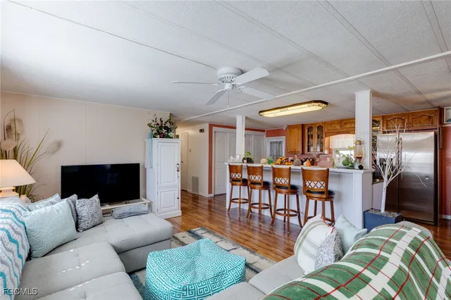 a living room with furniture a ceiling fan and a rug