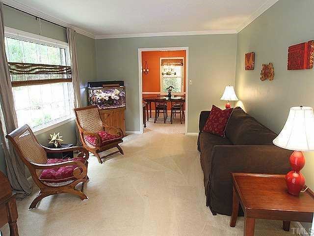 Enter this light filled sitting  room that flows to an inviting dining room from tiled entry foyer.