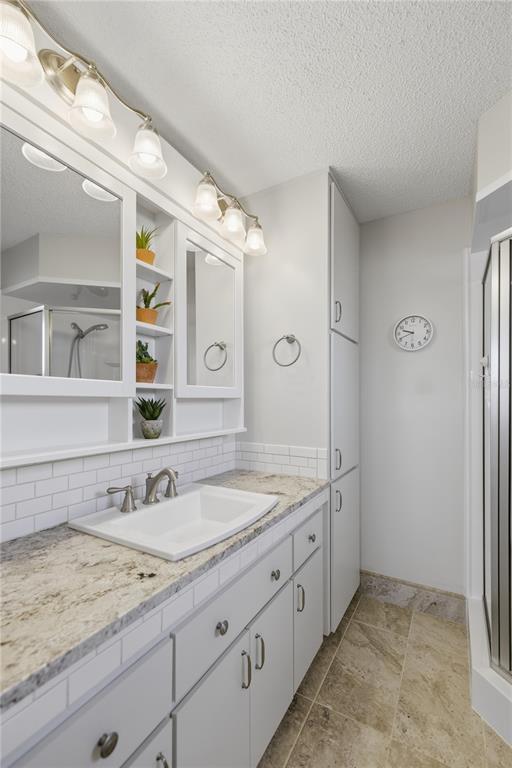 10492 Southeast 178th Street Summerfield, FL 34491 - Photo 18 of 32 a bathroom with a granite countertop sink and a mirror