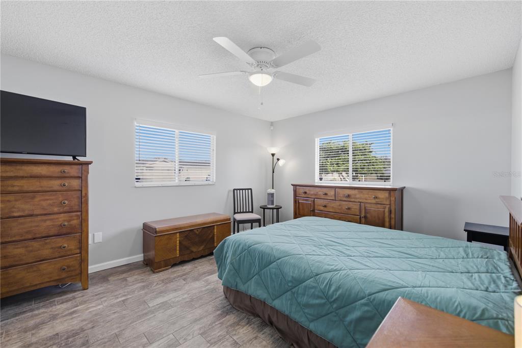 10492 Southeast 178th Street Summerfield, FL 34491 - Photo 19 of 32 a bedroom with a bed and a dresser