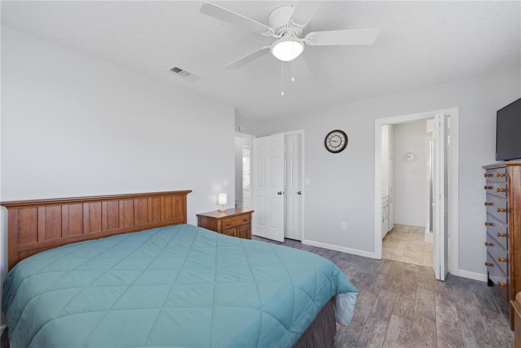 10492 Southeast 178th Street Summerfield, FL 34491 - Photo 20 of 32 a bedroom with a bed and a chandelier