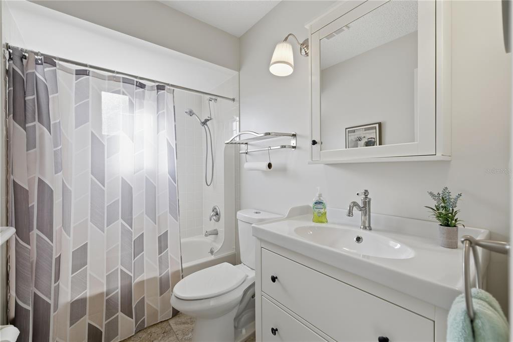 10492 Southeast 178th Street Summerfield, FL 34491 - Photo 10 of 32 a bathroom with a sink toilet a shower and a mirror