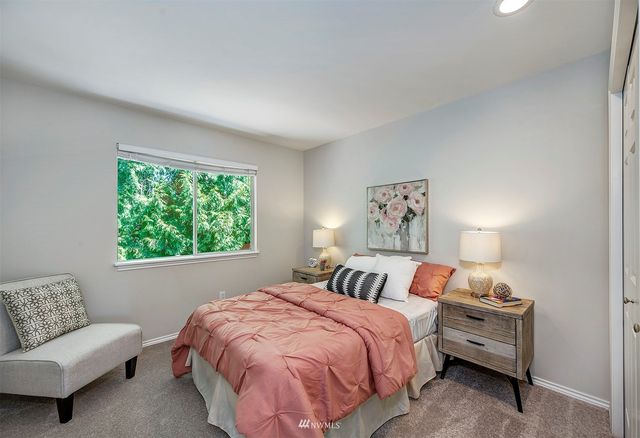 a bedroom with a bed and a couch