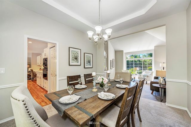a dining room with furniture a large window and wooden floor