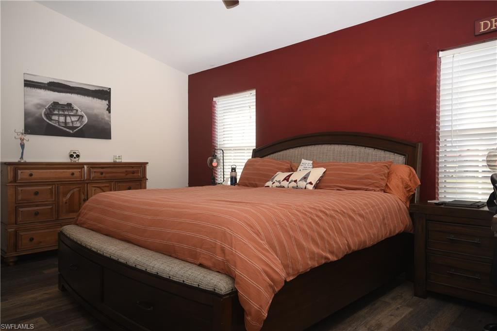 11738 Eros Road Lehigh Acres, FL 33971 - Photo 11 of 42 a bedroom with a bed and a window