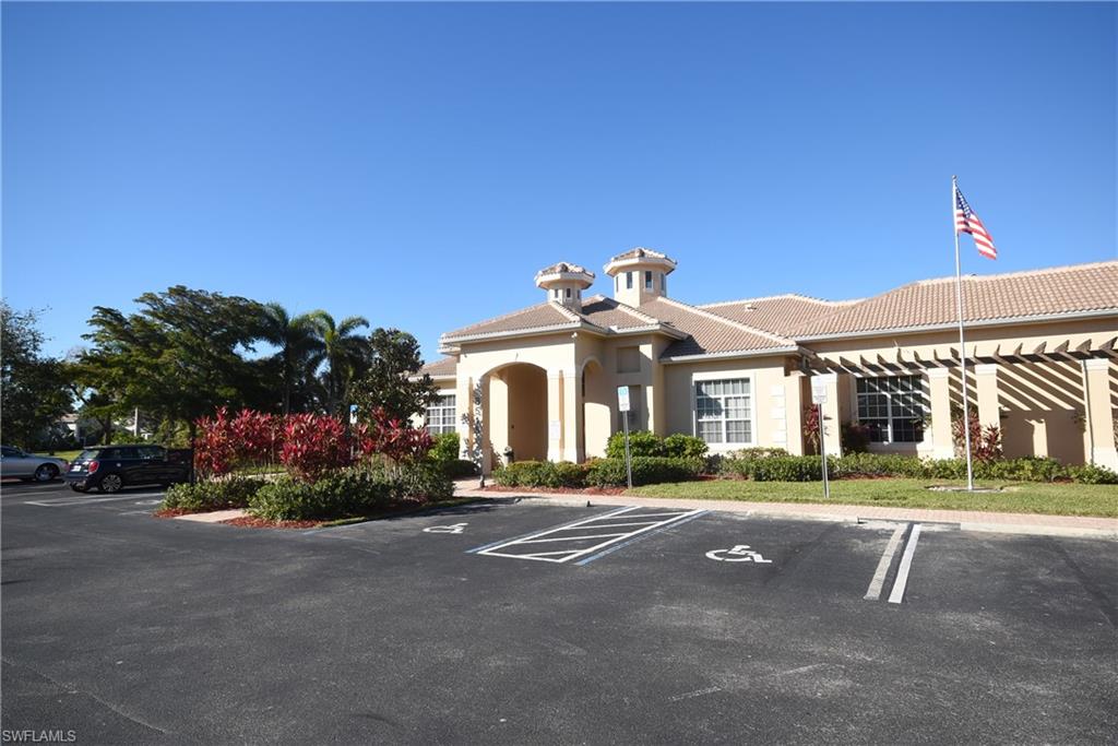 11738 Eros Road Lehigh Acres, FL 33971 - Photo 28 of 42 a front view of a house with a yard and a garage
