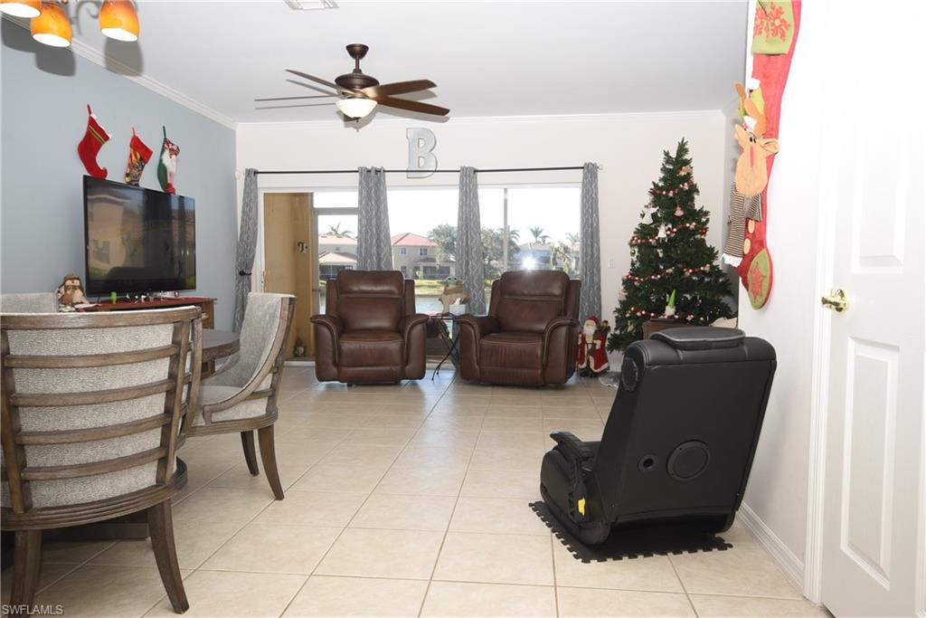 11738 Eros Road Lehigh Acres, FL 33971 - Photo 3 of 42 a living room with furniture and a flat screen tv