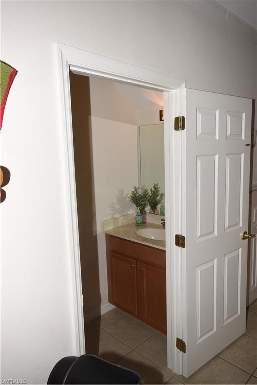 11738 Eros Road Lehigh Acres, FL 33971 - Photo 8 of 42 a bathroom with a sink and mirror