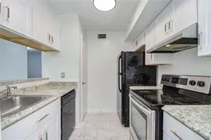 a kitchen with a stove and a refrigerator