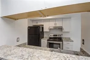 an empty room with closet and a chandelier fan