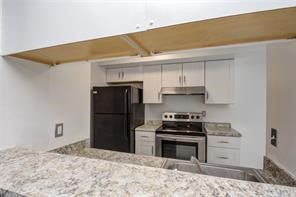 17331 Red Oak Drive, Unit 45 Houston, TX 77090 - Photo 12 of 25 a kitchen with a stove and a refrigerator