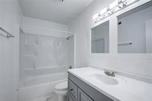 17331 Red Oak Drive, Unit 45 Houston, TX 77090 - Photo 17 of 25 a bathroom with a sink a toilet and shower