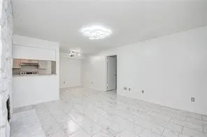 a view of a kitchen with a sink and refrigerator in it