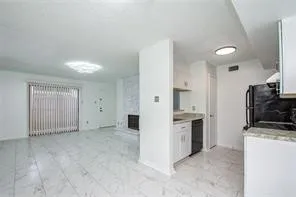 a kitchen with granite countertop a sink stove and cabinets