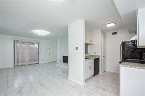 17331 Red Oak Drive, Unit 45 Houston, TX 77090 - Photo 7 of 25 a view of a kitchen with a sink stove and a refrigerator