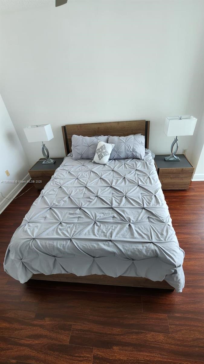 1250 South Miami Avenue, Unit 1913 Miami, FL 33130 - Photo 19 of 29 a bedroom with a bed and wooden floor