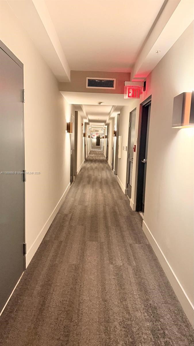 1250 South Miami Avenue, Unit 1913 Miami, FL 33130 - Photo 5 of 29 a view of a hallway with wooden walls and stairs