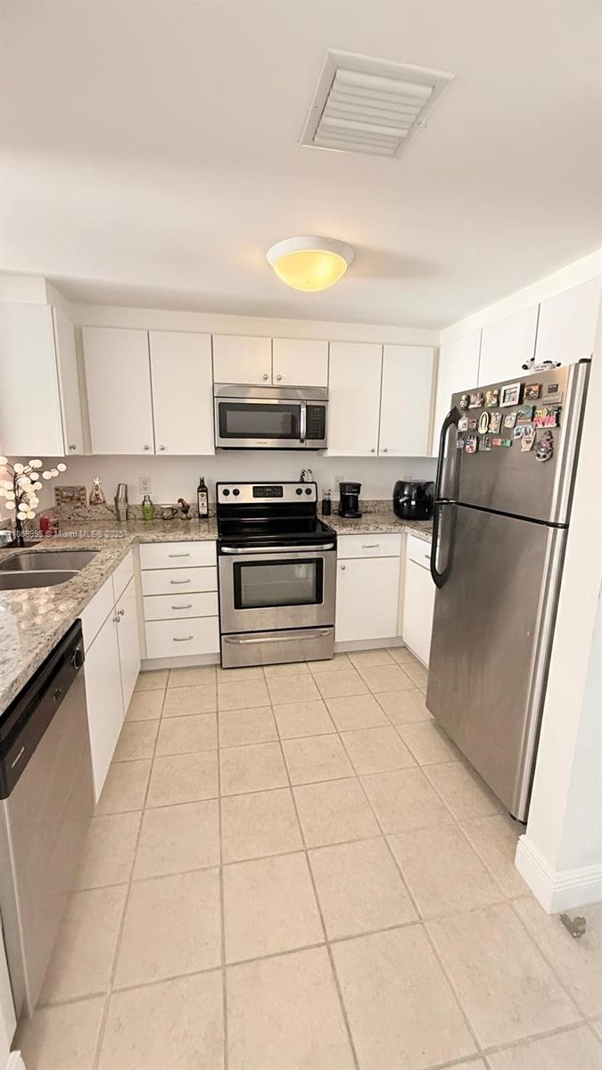 1250 South Miami Avenue, Unit 1913 Miami, FL 33130 - Photo 8 of 29 a kitchen with a sink a counter top space and appliances