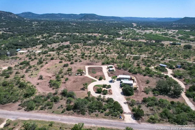 an aerial view of multiple house with a mountain