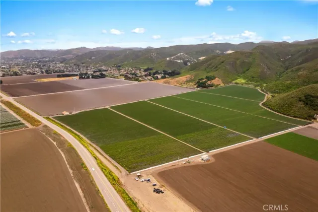 an aerial view of mountains residential house and green space