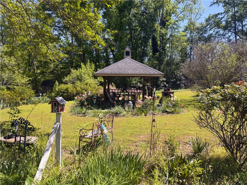 208 Knoxwood Court Anderson, SC 29621 - Photo 32 of 38 A charming gazebo and lush garden create an inviting outdoor sanctuary.