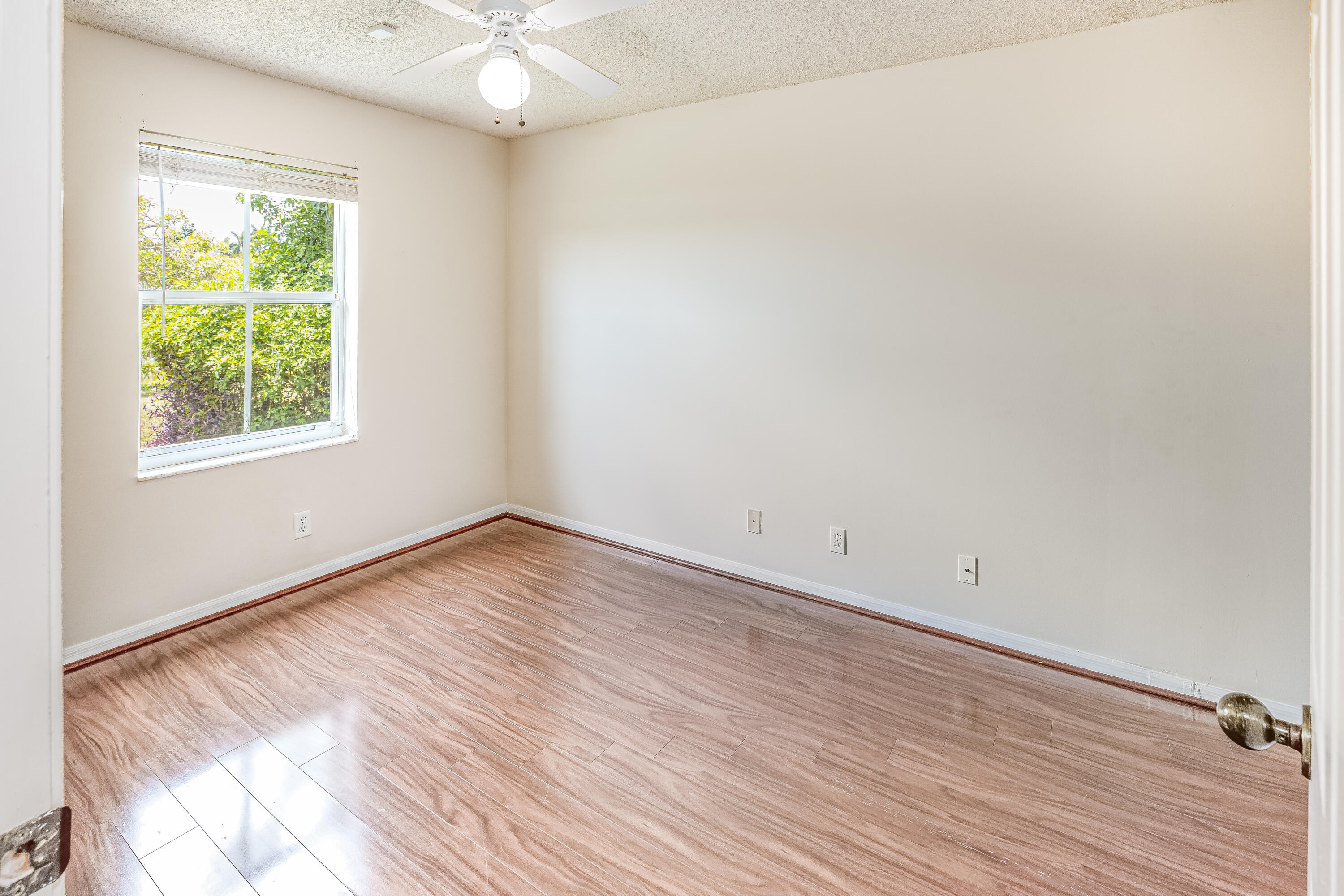 4244 Pine Ridge Court Weston, FL 33331 - Photo 18 of 34 an empty room with wooden floor and windows