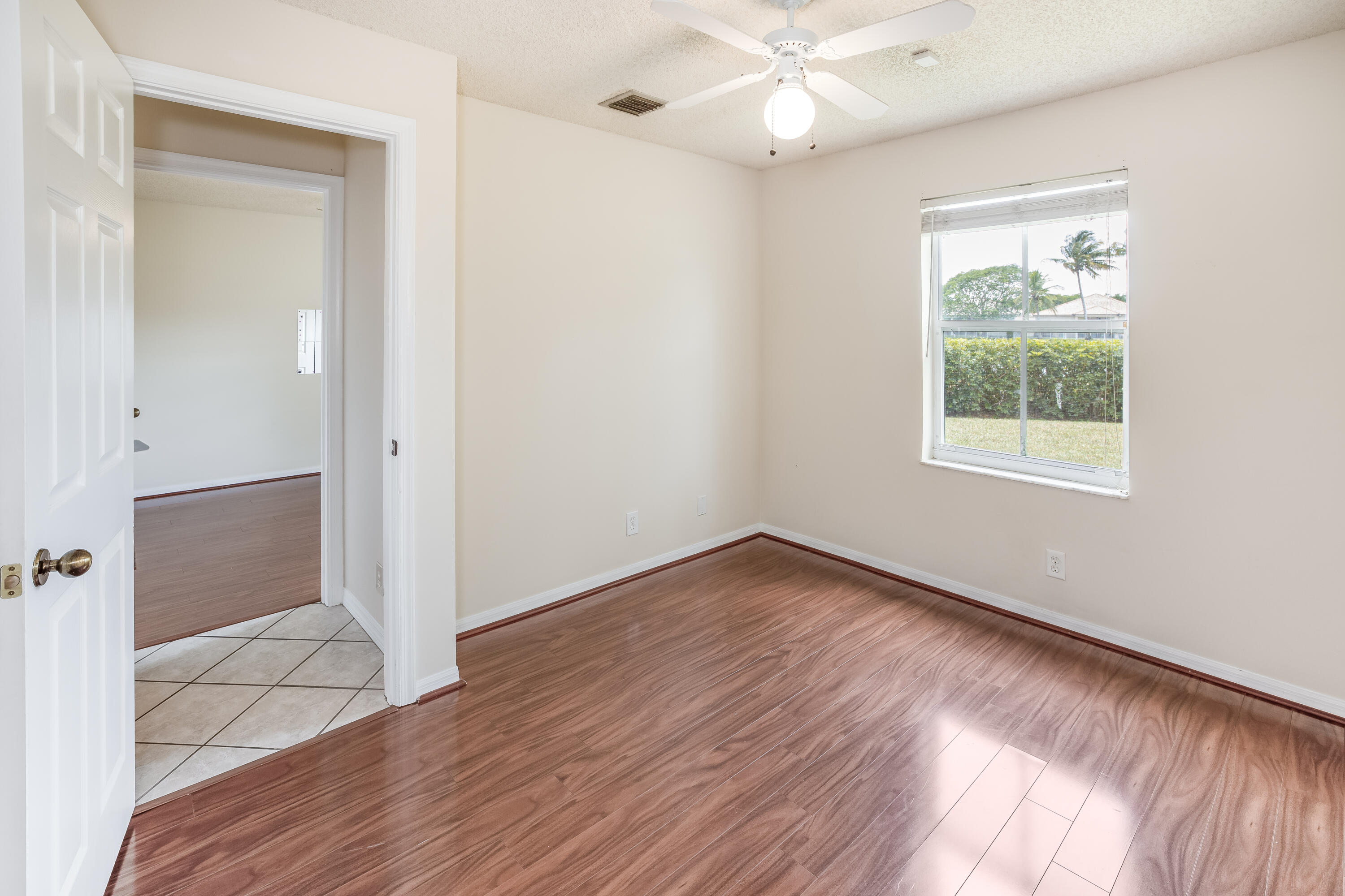 4244 Pine Ridge Court Weston, FL 33331 - Photo 19 of 34 a view of an empty room with wooden floor and a window