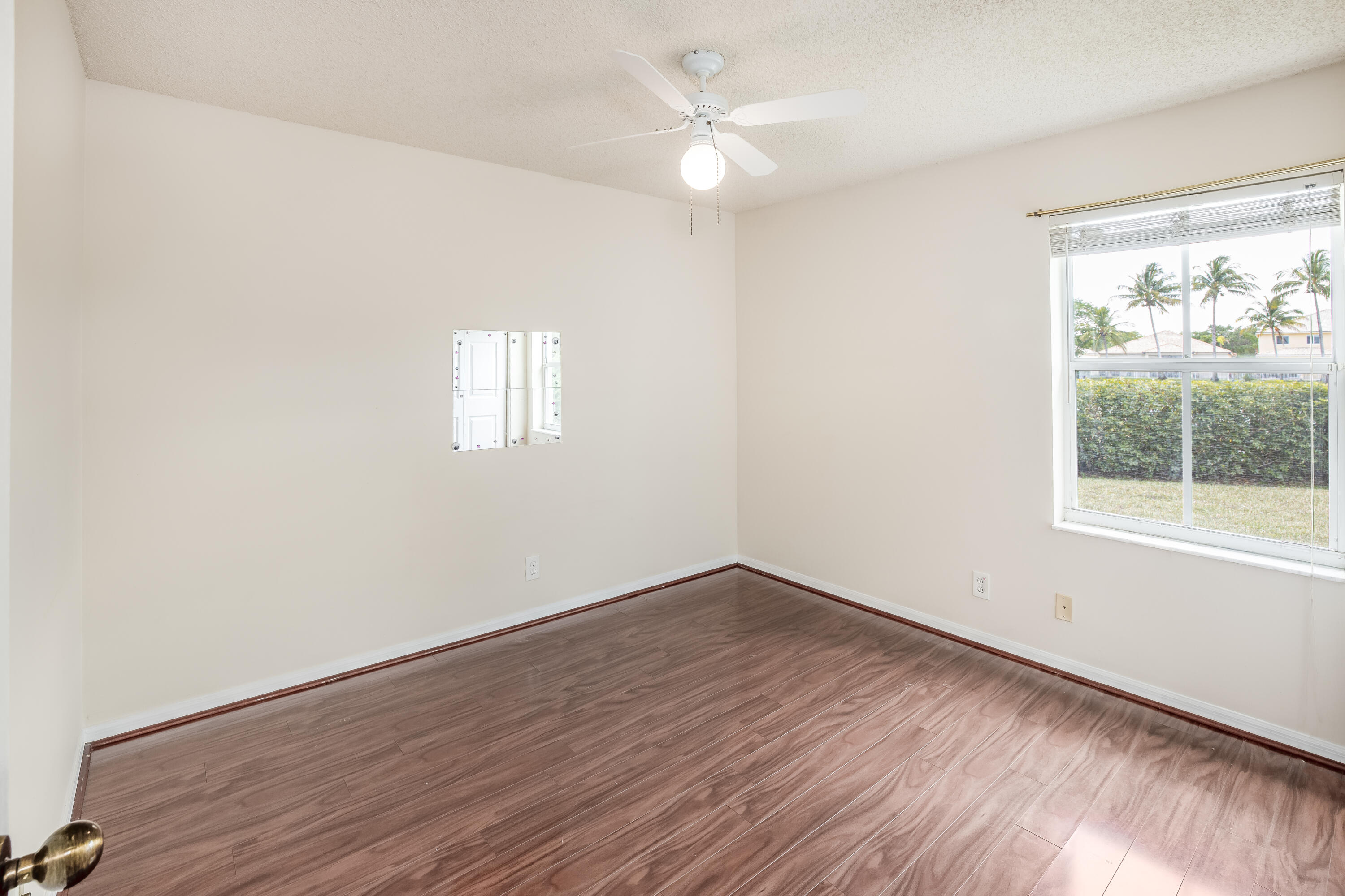 4244 Pine Ridge Court Weston, FL 33331 - Photo 20 of 34 an empty room with wooden floor and windows