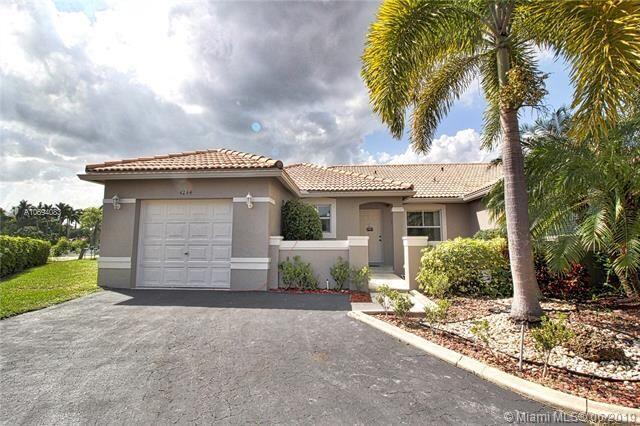 4244 Pine Ridge Court Weston, FL 33331 - Photo 2 of 34 a front view of a house with a yard