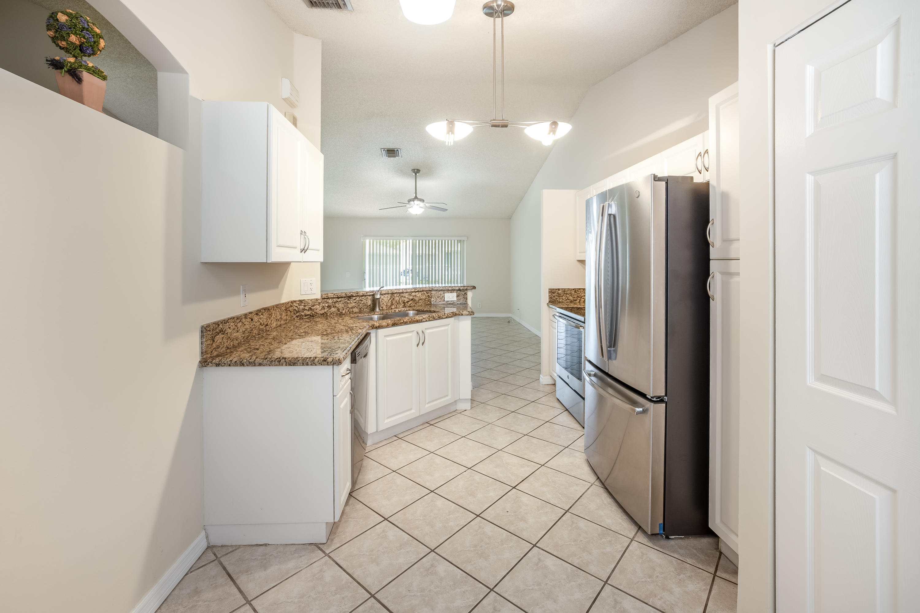 4244 Pine Ridge Court Weston, FL 33331 - Photo 6 of 34 a kitchen with a refrigerator a sink and dishwasher