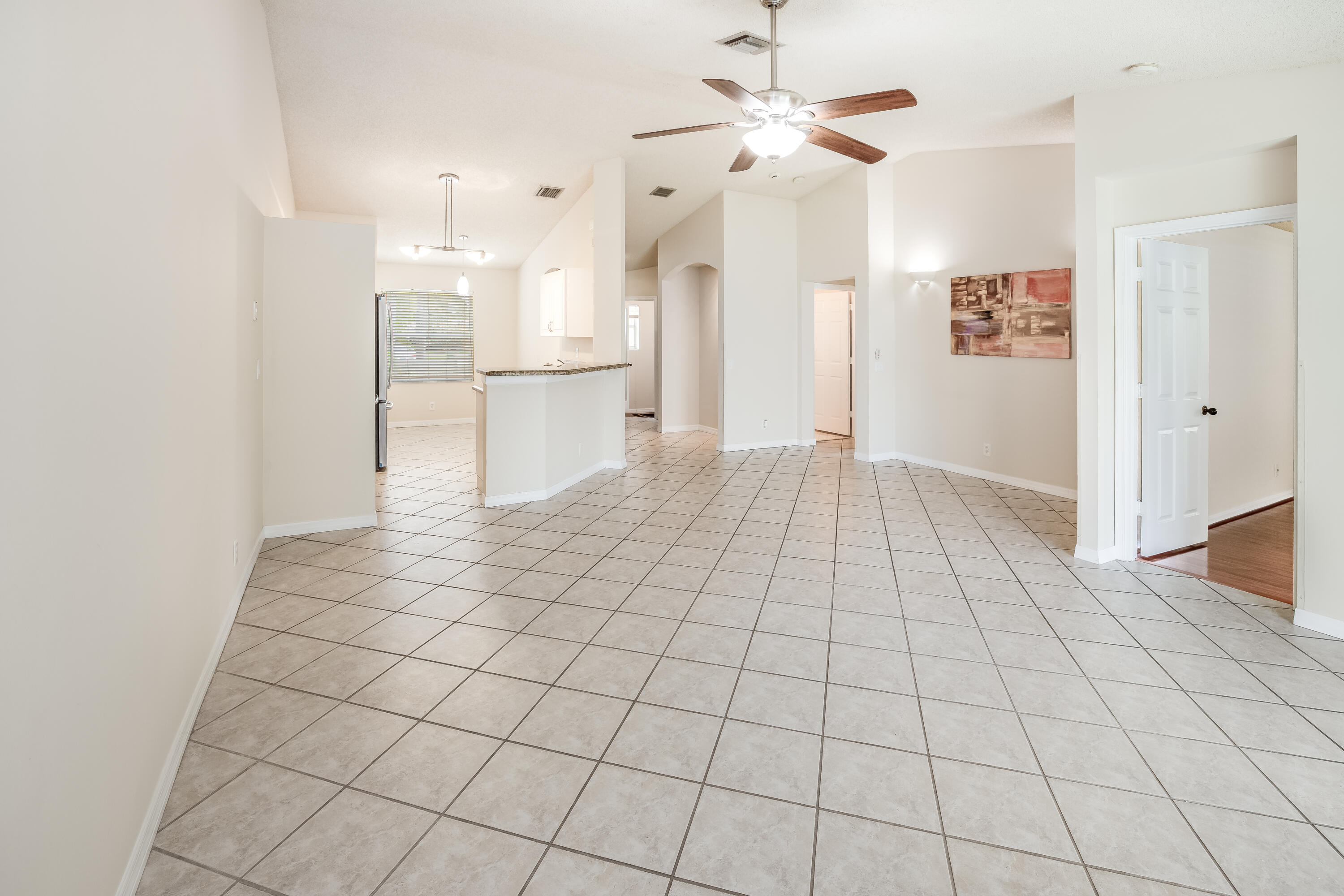 4244 Pine Ridge Court Weston, FL 33331 - Photo 10 of 34 a view of empty room with kitchen view and a window